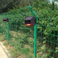 Black solar alarm sensor on green fence, red light glowing