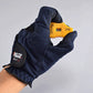 PGM gourd-shaped golf score counter held in navy glove hand, orange body
