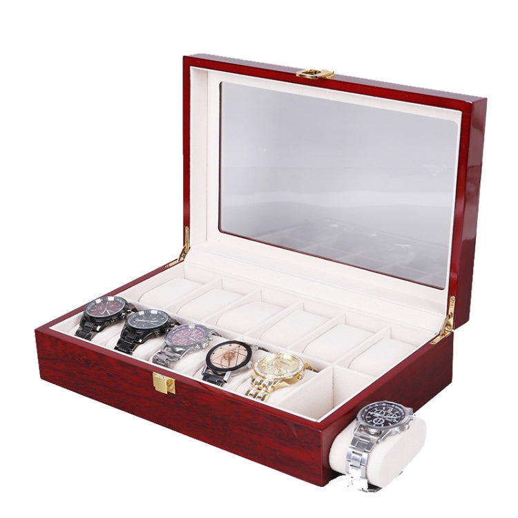 Red wooden watch box open with clear window lid and multiple watch holders