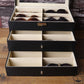 Black sunglasses organizer case with interior dividers holding pairs of eyeglasses