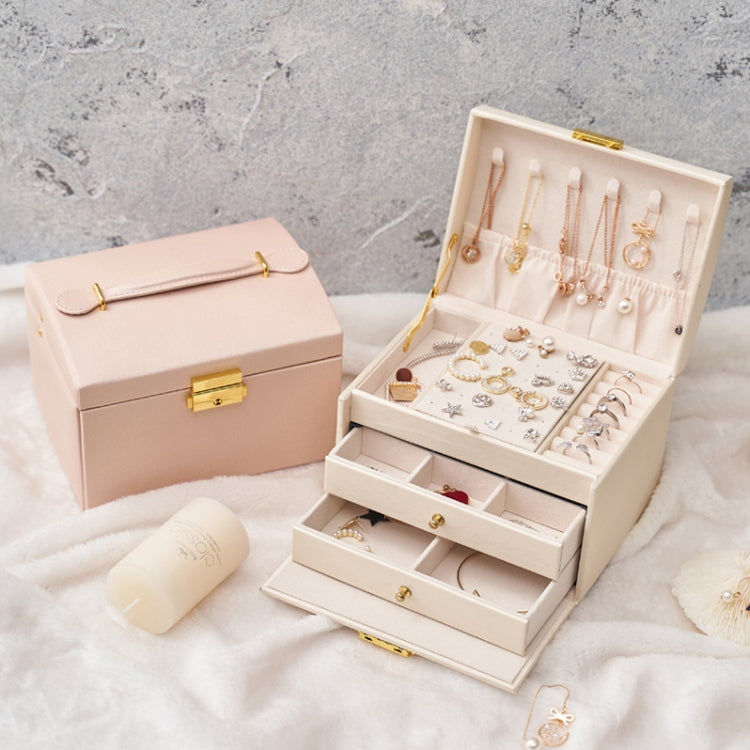 Nude pink jewelry storage box with open lid and visible tiered earring and ring areas