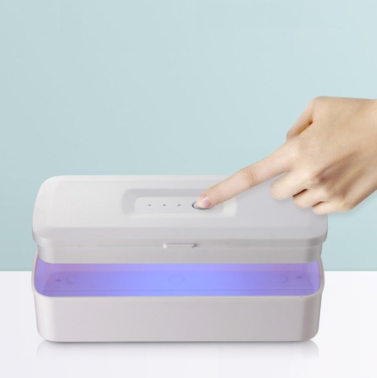 White UV sterilization box with purple light strip and hand lifting the lid