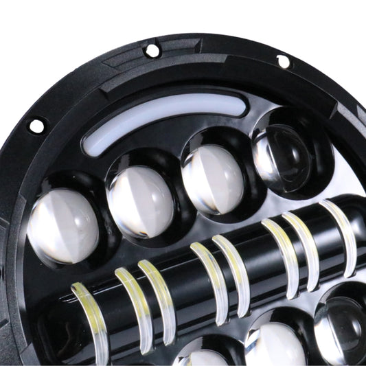 Close-up LED motorcycle headlight with chrome reflectors, clear lenses, and bar LEDs