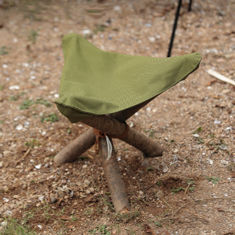 Olive green triangle cloth cover draped over a wooden tripod stool