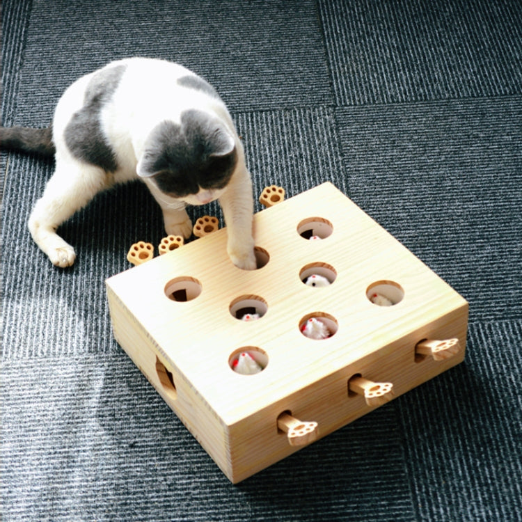 Wooden cat puzzle box with paw-shaped openings and multiple fuzzy ball toys.