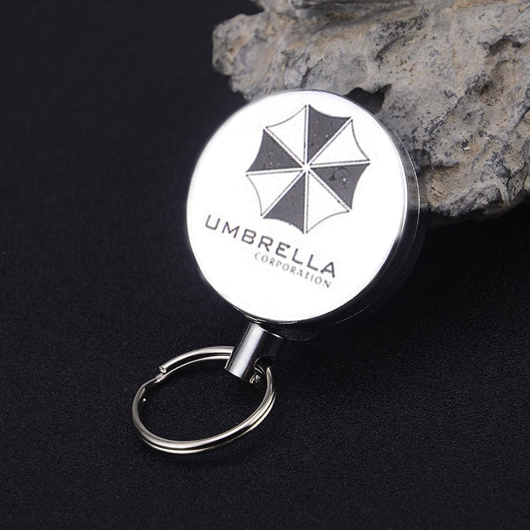 Retractable wire-rope key ring with round printed umbrella emblem and metal loop