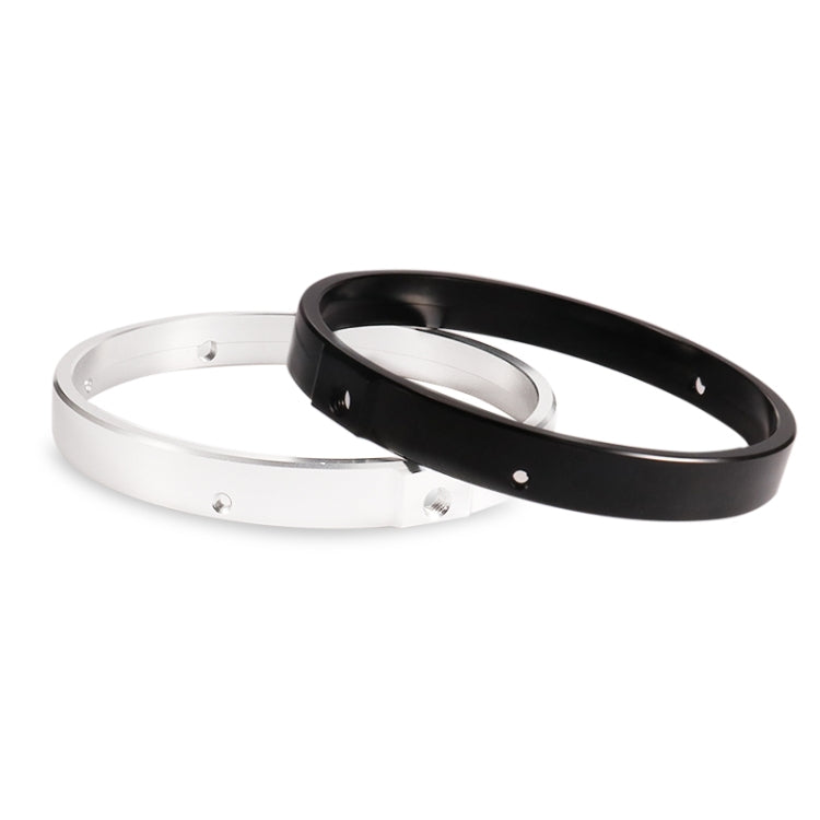 Silver and black motorcycle headlight mounting rings together