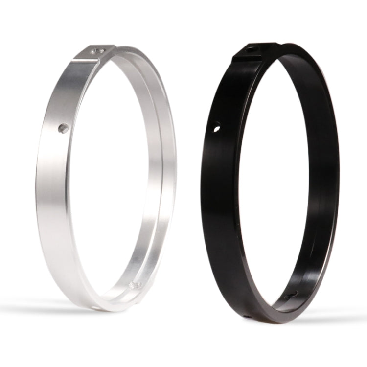 Silver and black headlight mounting rings, side profile view