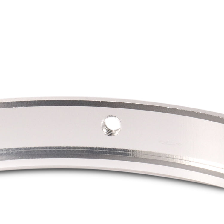 Close-up of silver motorcycle headlight ring with central mounting hole