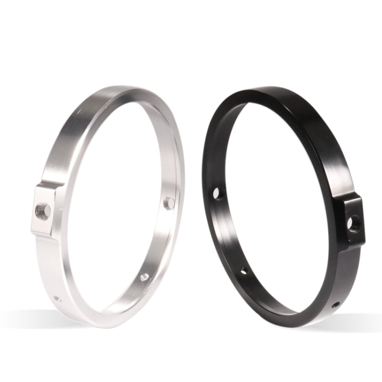 Two motorcycle headlight rings side by side: silver and black