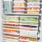 Multiple refrigerated storage containers neatly stacked inside freezer shelves