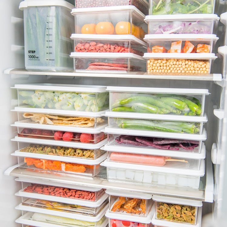 Multiple refrigerated storage containers neatly stacked inside freezer shelves