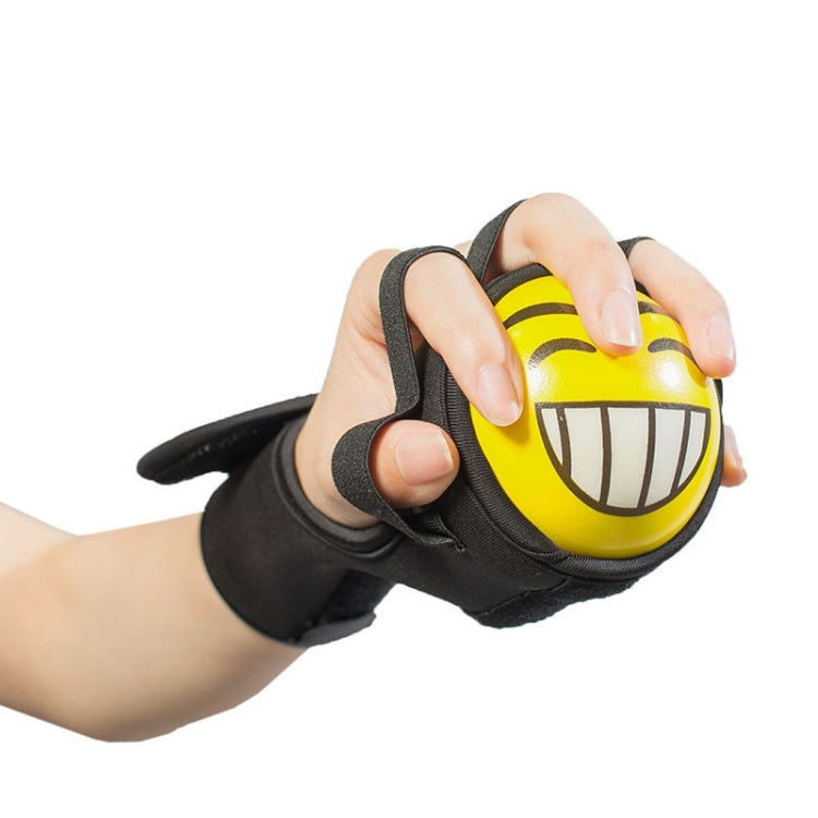 Hands holding yellow grip ball in black wrist strap hand exerciser