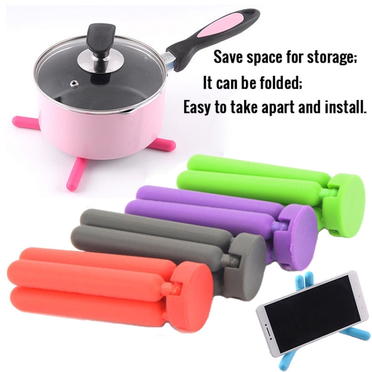 Folded silicone pot mat arms in pink, green, purple, gray, and orange for space-saving storage.