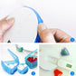 Hands holding a white pill box with blue ring, showing open compartments for pills