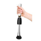 Electric makeup brush cleaner held by hand with brush attachment