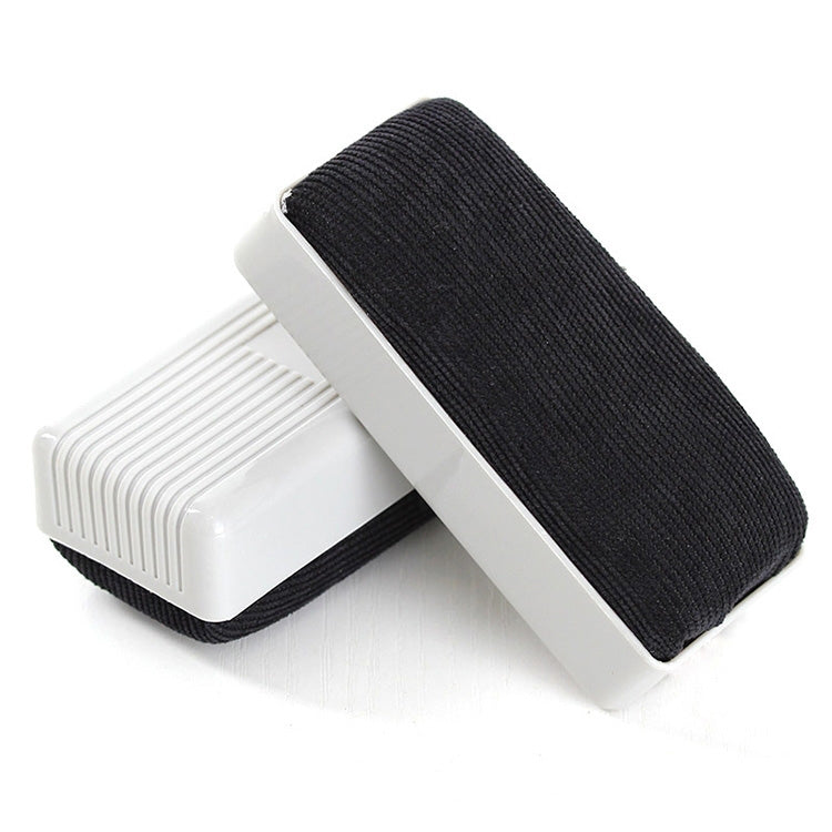 Handheld whiteboard eraser with black felt pad and white plastic frame