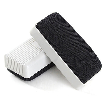 Handheld whiteboard eraser with black felt pad and white plastic frame
