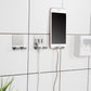 Multiple stainless steel razor hooks mounted on bathroom tiles