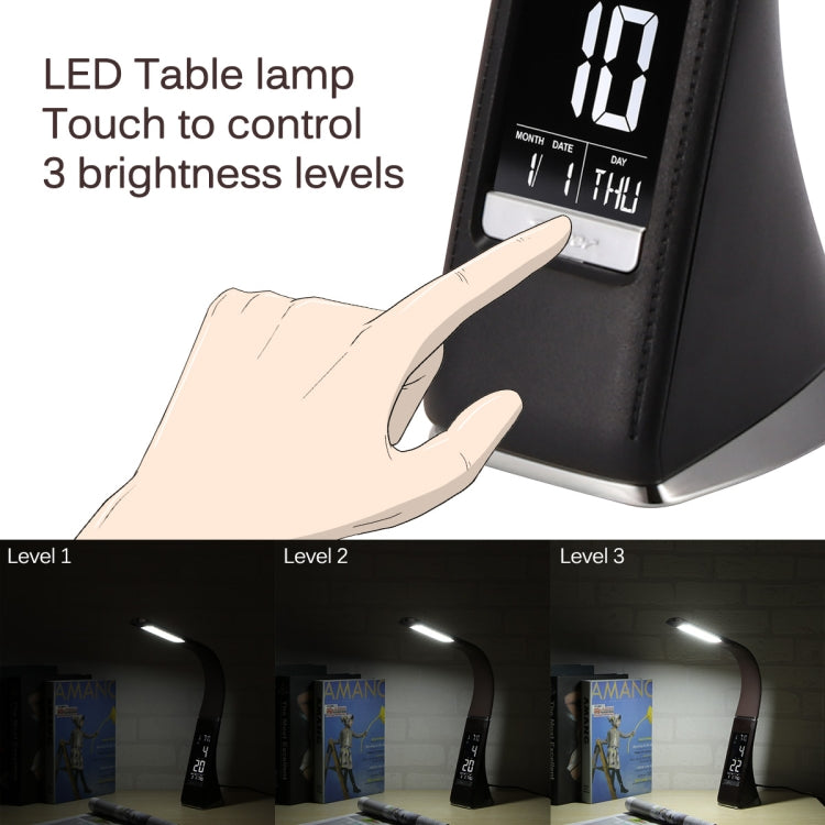 Black LED desk lamp with digital display and touch control; hand pointing at panel