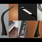 Black LED desk lamp with arched neck and digital time display on the base