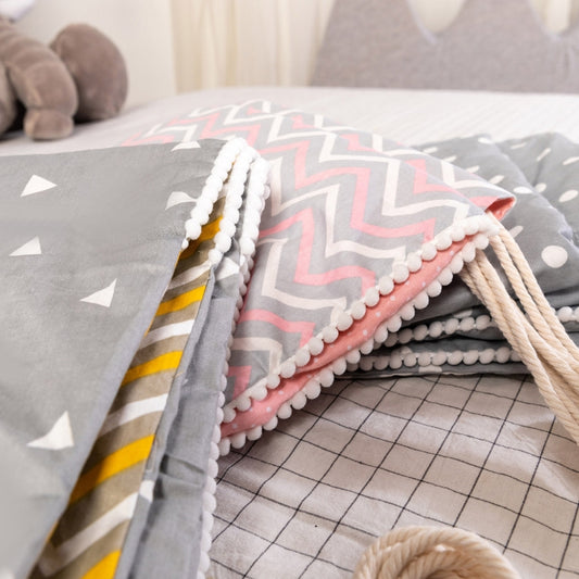 Kids hanging hammock with pink, white and gray zigzag layers and thick braided side ropes