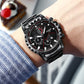 Men's waterproof sports watch on wrist; black metal bracelet and black dial with red markers