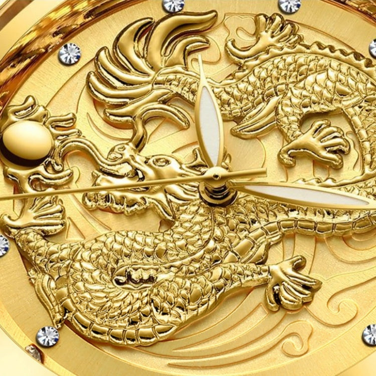 Gold dial close-up showing detailed dragon relief and small clear stone markers around edges.