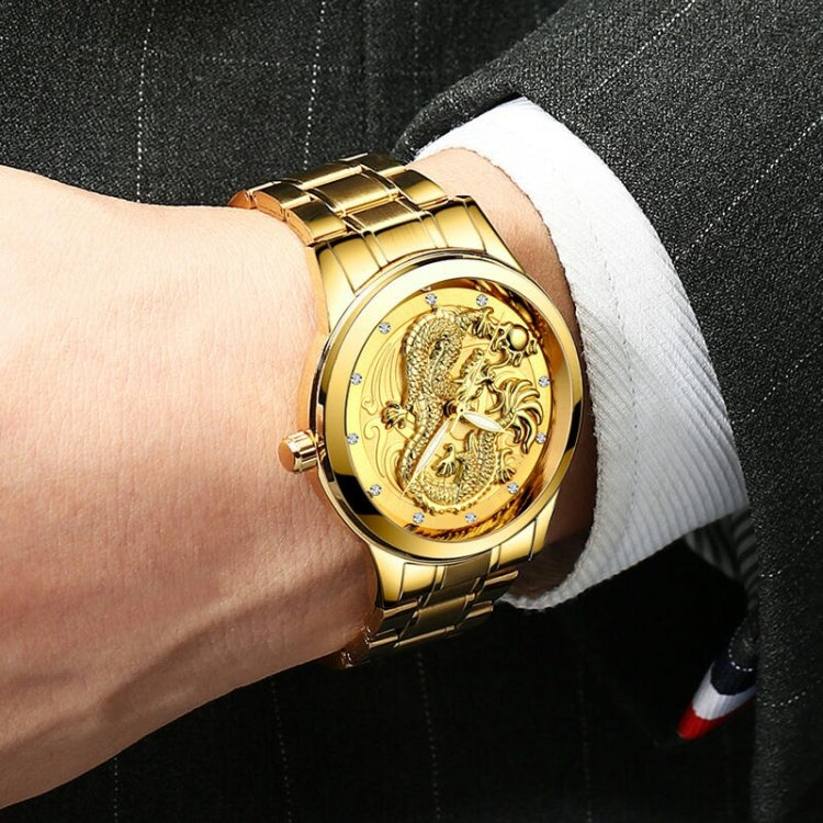 Gold-tone bracelet watch on wrist with dragon dial and small crystal markers.