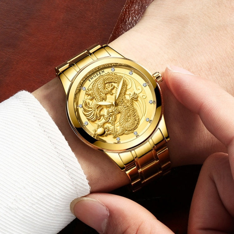 Gold-tone round watch on wrist with dragon dial, crystal dots, and gold link bracelet.
