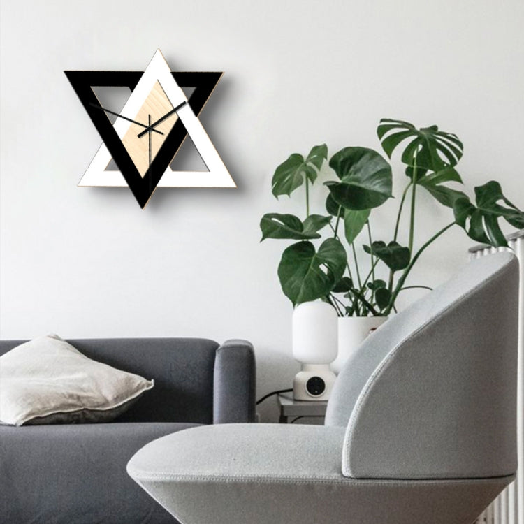 Star-shaped geometric wall clock with black and white frame, light wood center, black hands