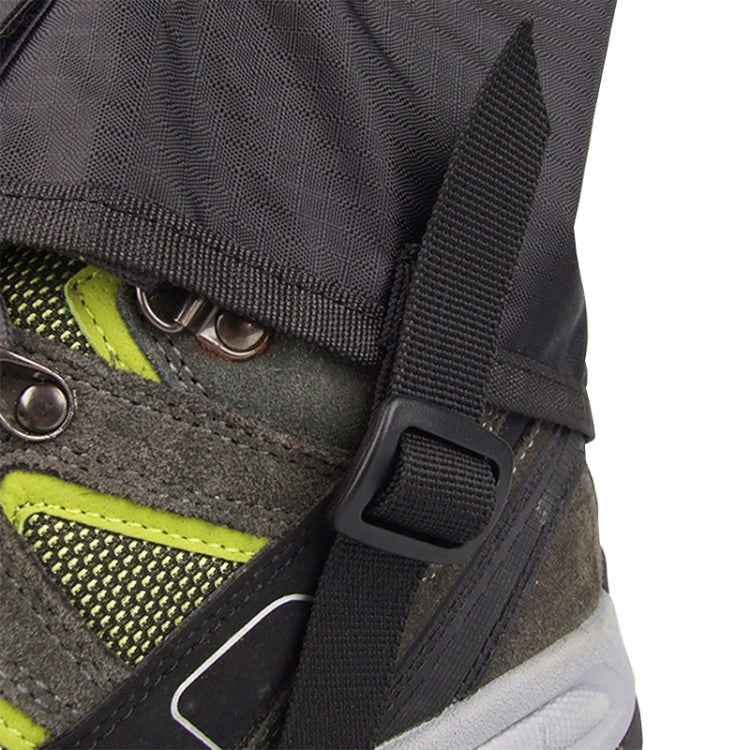 Black foot cover with hook-and-buckle strap over green mesh shoe panel