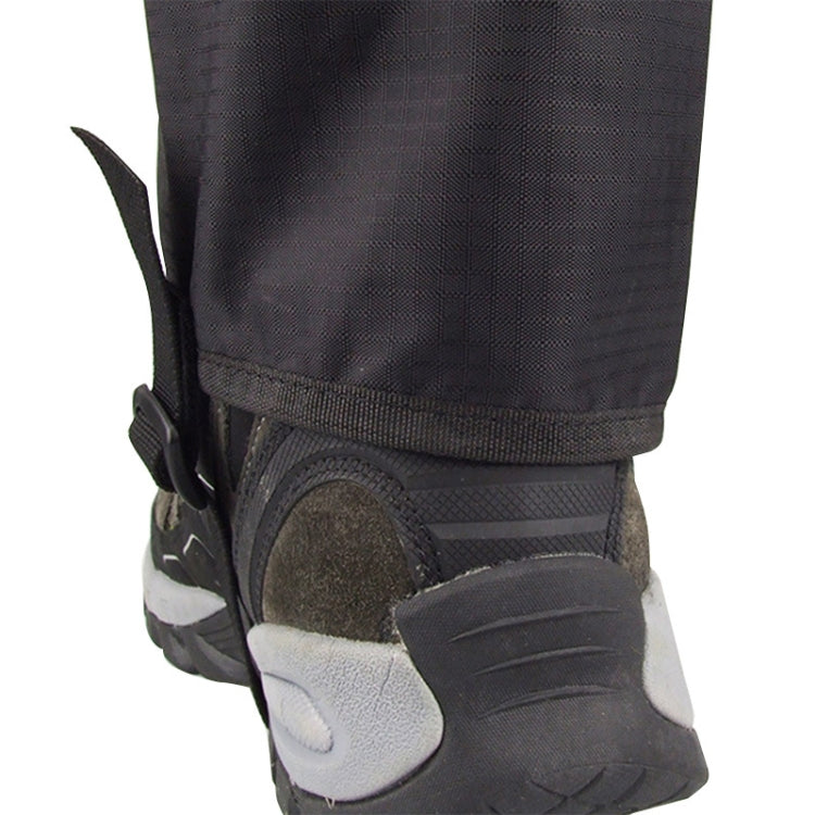 Black foot cover with elastic cuff over shoe toe and treaded sole