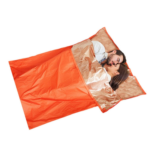 Heat-reflective emergency thermal blanket with red outer and silver lining, open for use