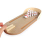 Desktop wooden bowling puzzle toy showing pins on playfield and front ball slide