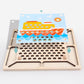 Wooden pegboard tray with many holes and a seaside picture card for bead placement