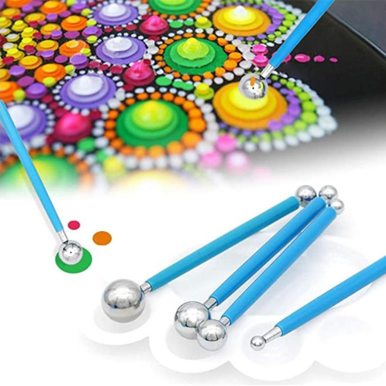 Blue dotting pens with metal ball tips for making colorful mandala designs on stone