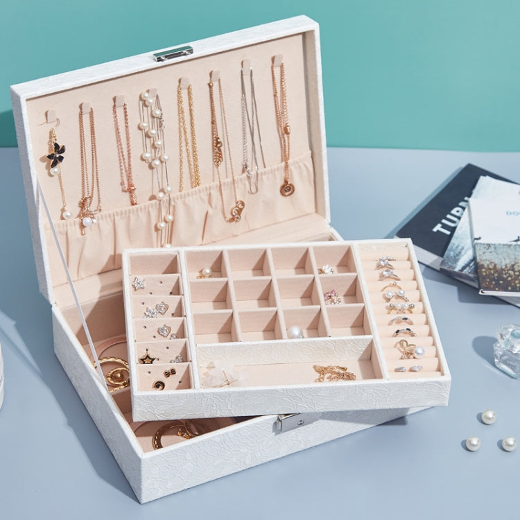 Open white jewelry box with multi-tier compartments for rings, bracelets, and necklaces