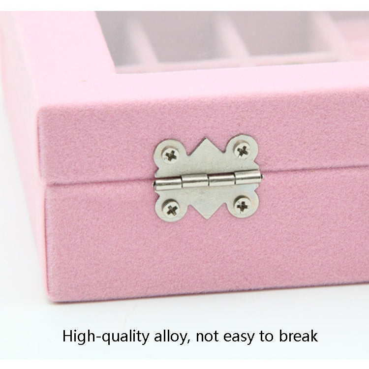 Close-up of metal hinge latch on pink flannel jewelry storage box