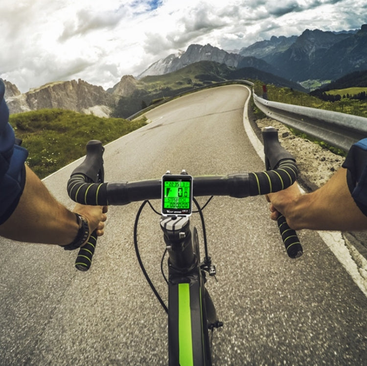 Handlebar-mounted bike speedometer with large green backlit display and wiring