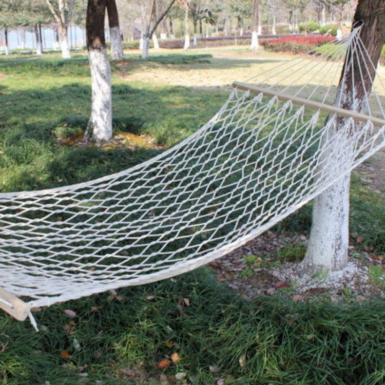 White cotton rope mesh hammock with light wood spreader bar