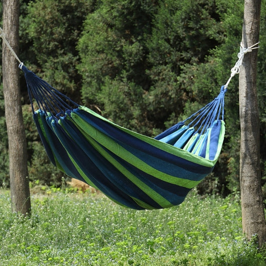 Blue and green striped canvas hammock with fringed ends and hanging ropes