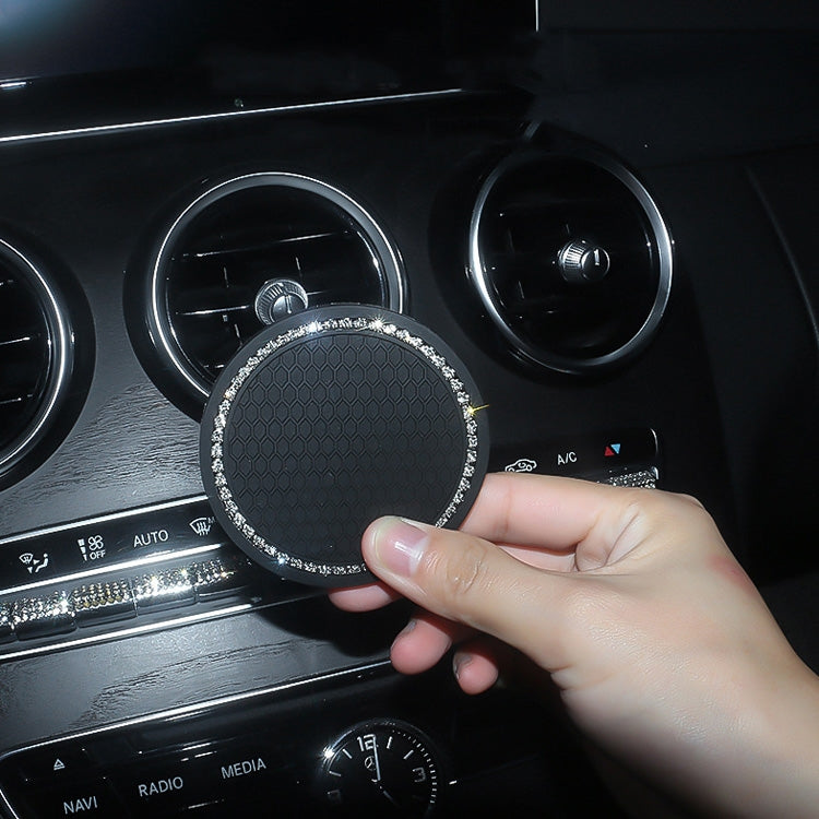 Black honeycomb car cup coaster with rhinestone border installed in a dashboard cup holder.