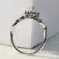 Top view of sterling silver ring band with prong-set multicolor faceted gemstone