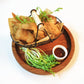 Black wire snack basket with two cup holders and wooden handle
