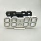 3D LED alarm clock front with white 3D digits and dark back panel
