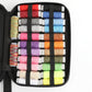Sewing kit case with stacked colorful thread spools and black bands