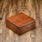 Closed 6-slot wooden watch storage box with rounded keyhole lock and smooth top lid