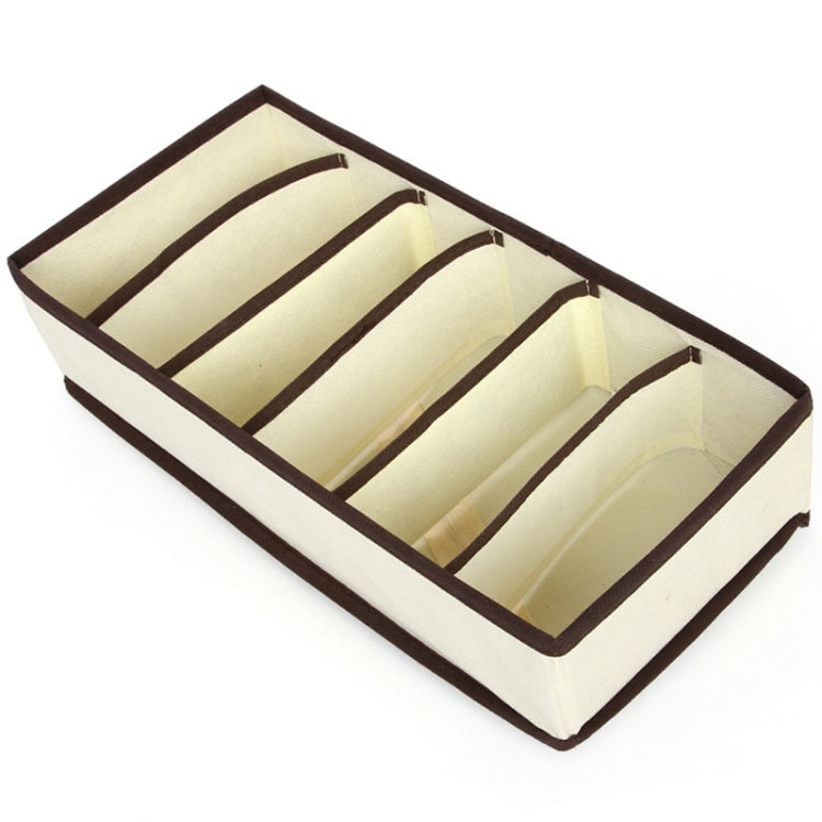 Beige fabric organizer box with brown-lined divider grid for neatly storing lingerie