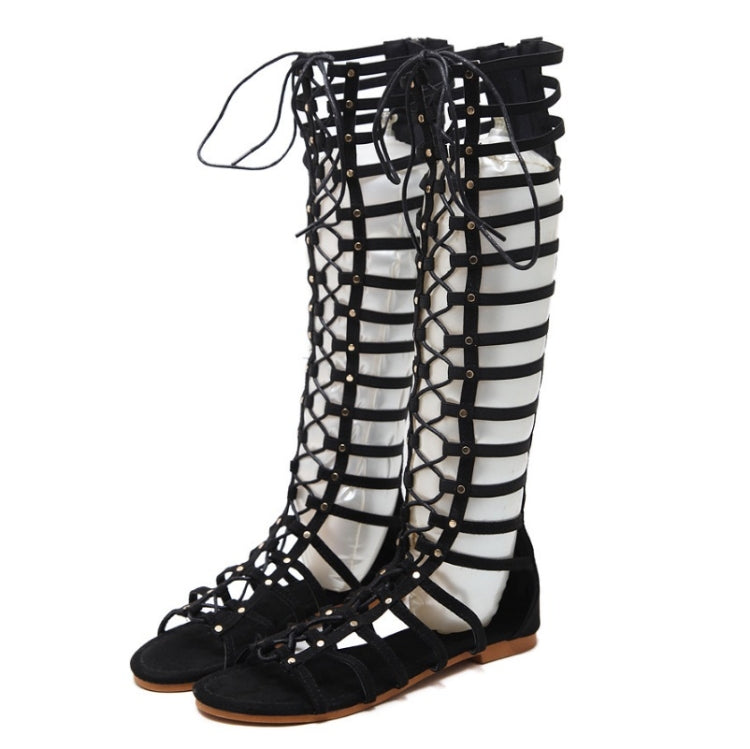 Black gladiator flat sandals with hollow straps, metal eyelet details, lace-up ankle